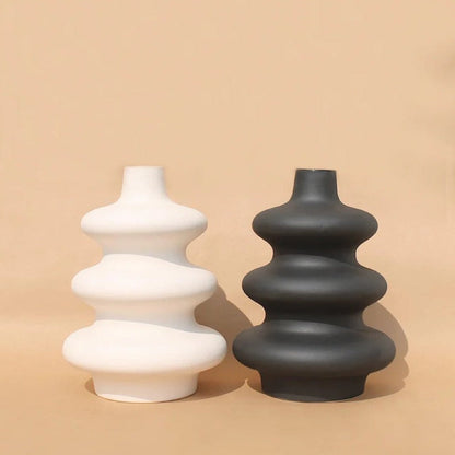 : White Mezo decorative vase with soft organic curves and a modern minimalist finish.