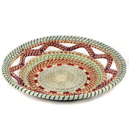Side view of the Celestina pine needle basket with gently sloping woven sides.